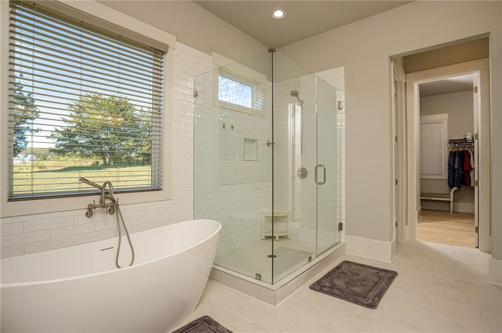 255 Old Town Road Dacula, GA 30019 - Photo 5 of 38 a bathroom with a bathtub and a shower