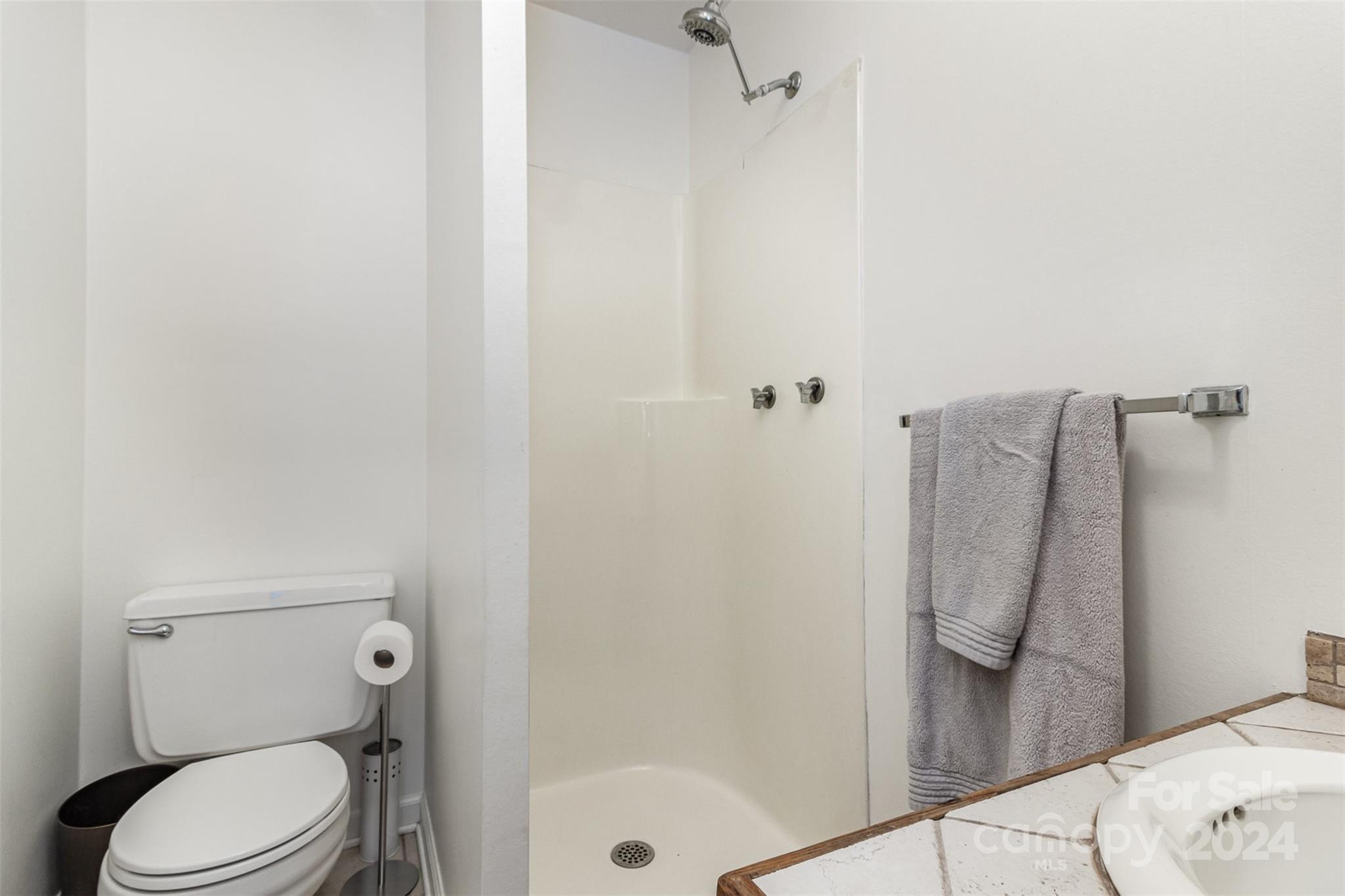 808 Dogwood Drive Lowell, NC 28098 - Photo 21 of 36 a bathroom with a toilet and shower