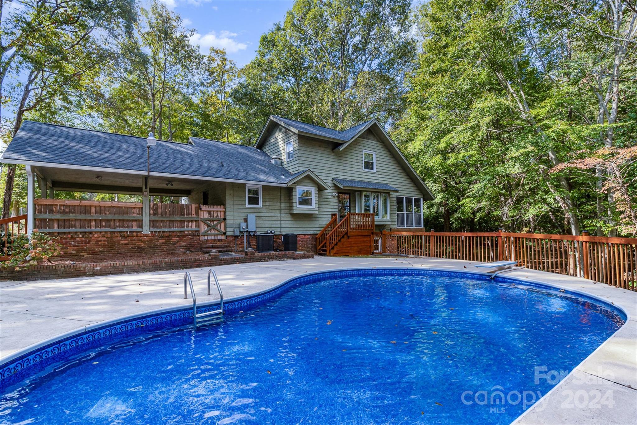 808 Dogwood Drive Lowell, NC 28098 - Photo 29 of 36 a house view with swimming pool in front of it