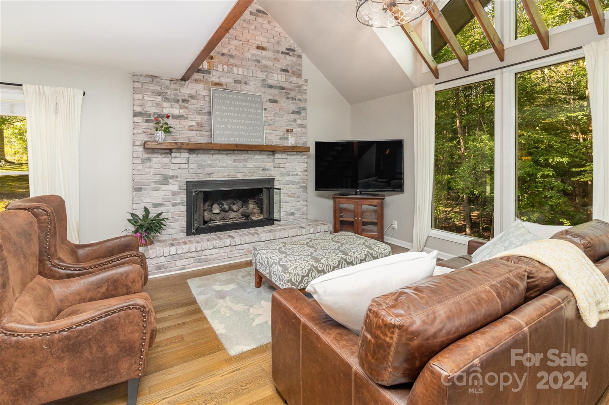 808 Dogwood Drive Lowell, NC 28098 - Photo 5 of 36 a bedroom with a bed a couch and large window