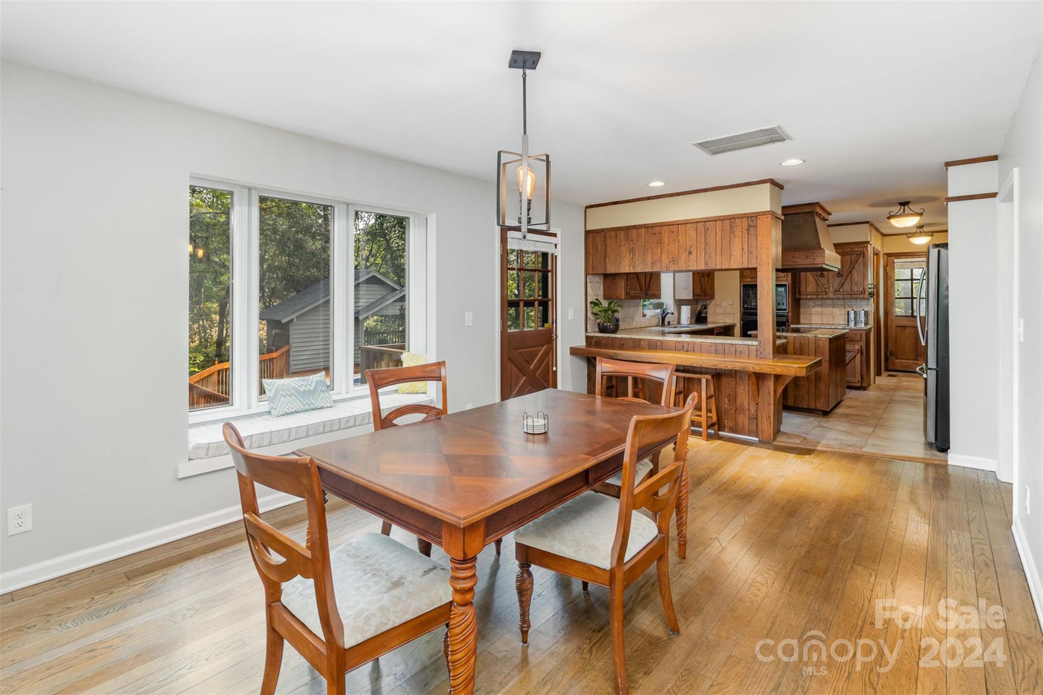808 Dogwood Drive Lowell, NC 28098 - Photo 8 of 36 a view of a dining room with furniture window and wooden floor