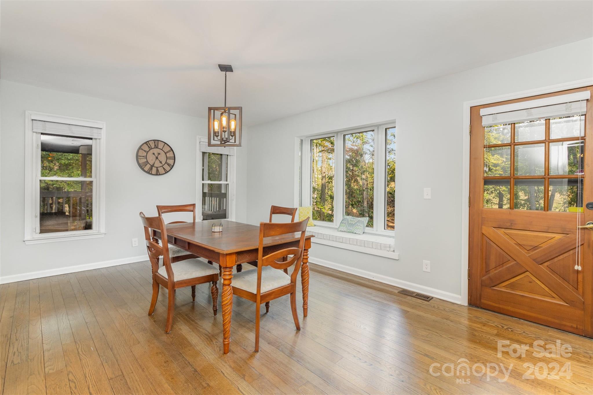 808 Dogwood Drive Lowell, NC 28098 - Photo 9 of 36 a view of a dining room with furniture window and wooden floor