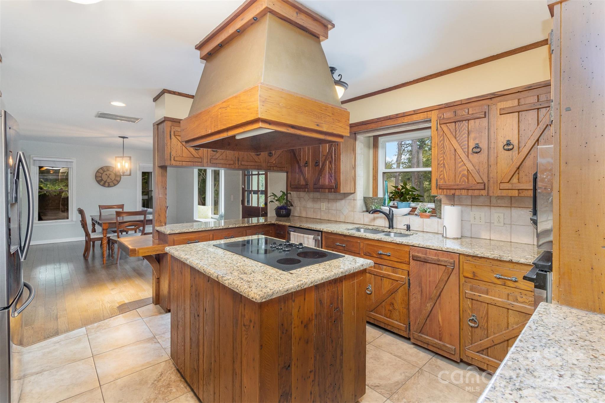 808 Dogwood Drive Lowell, NC 28098 - Photo 10 of 36 a kitchen with stainless steel appliances granite countertop a sink and a wooden cabinets