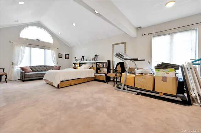 a bed room with a bed couch and a window