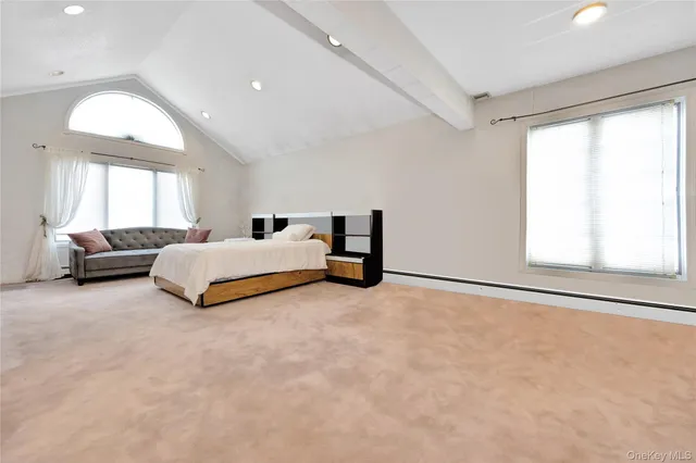 a spacious bedroom with a bed and a large window