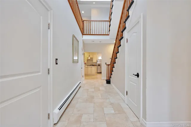 a view of a hallway with wooden floor and entryway