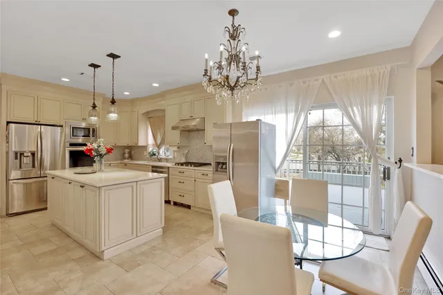 a kitchen with white cabinets and refrigerator