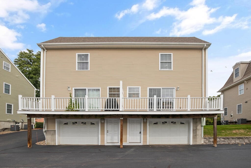 22 School Street, Unit 1 Waltham, MA 02452 - Photo 12 of 12 a front view of a house with a garage