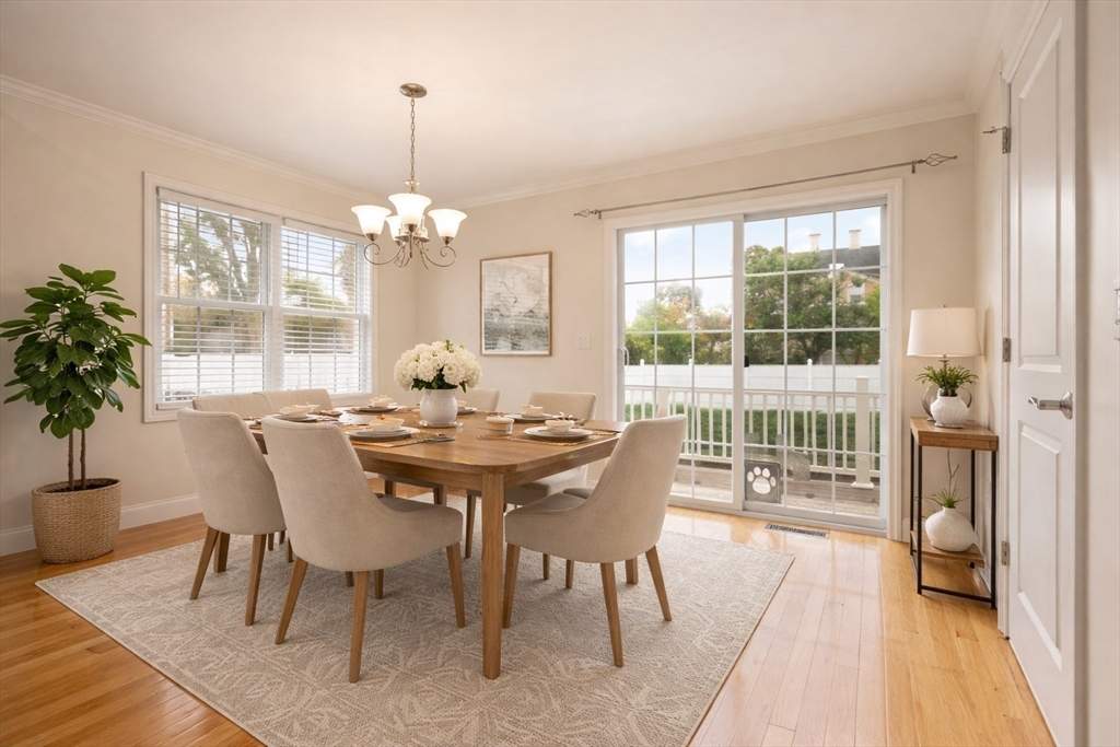 22 School Street, Unit 1 Waltham, MA 02452 - Photo 2 of 12 a view of a dining room with furniture wooden floor and chandelier