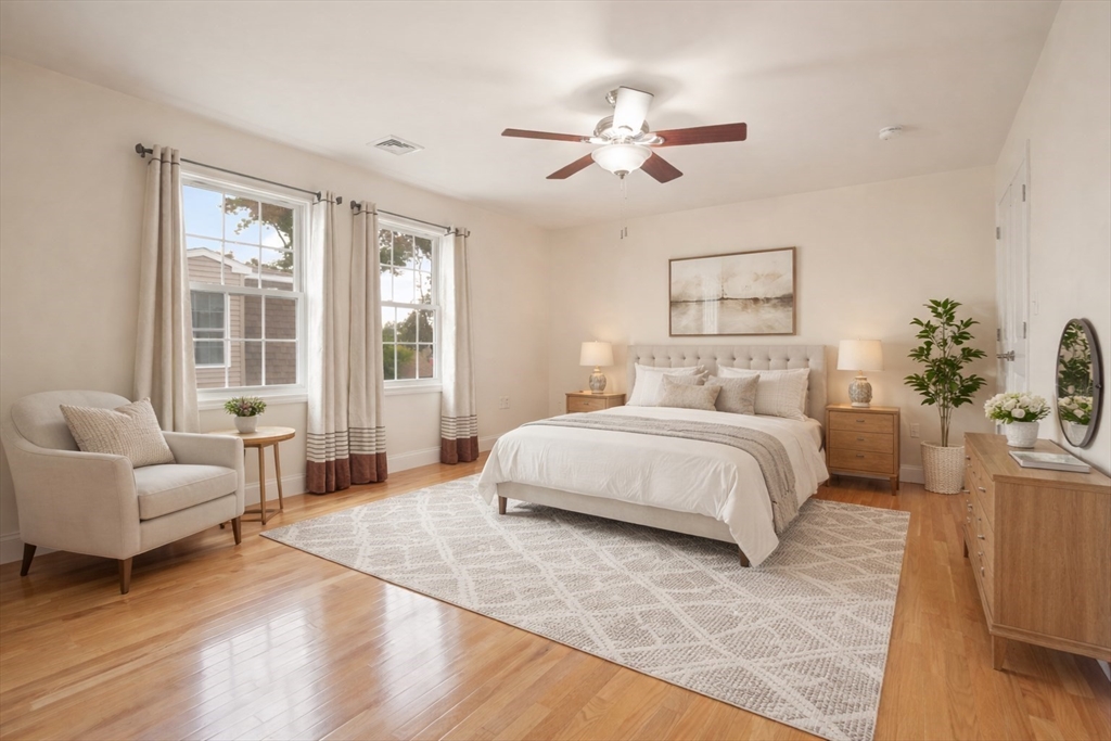 22 School Street, Unit 1 Waltham, MA 02452 - Photo 5 of 12 a bedroom with a large bed and a couch