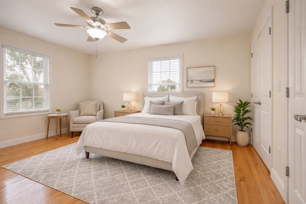 22 School Street, Unit 1 Waltham, MA 02452 - Photo 6 of 12 a bedroom with a large bed and a chandelier