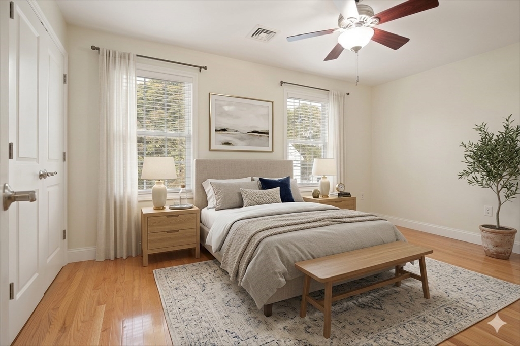 22 School Street, Unit 1 Waltham, MA 02452 - Photo 7 of 12 a bedroom with a bed and a chandelier