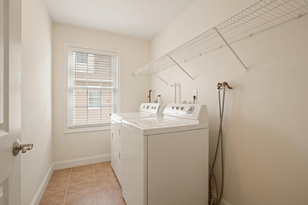 22 School Street, Unit 1 Waltham, MA 02452 - Photo 9 of 12 a utility room with closet dryer and washer