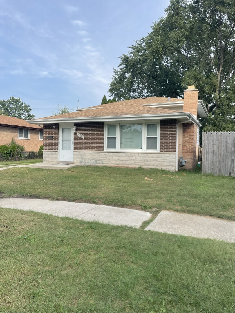 14647 Irving Avenue Dolton, IL 60419 - Photo 1 of 24 a front view of a house with a yard