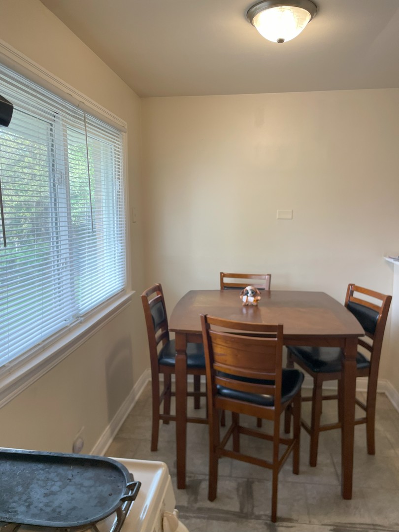 14647 Irving Avenue Dolton, IL 60419 - Photo 11 of 24 a view of a dining room with furniture and wooden floor