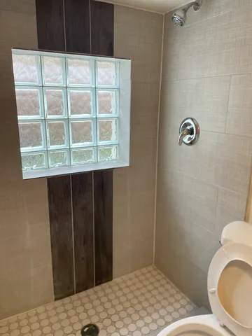 a bathroom with a sink toilet and mirror