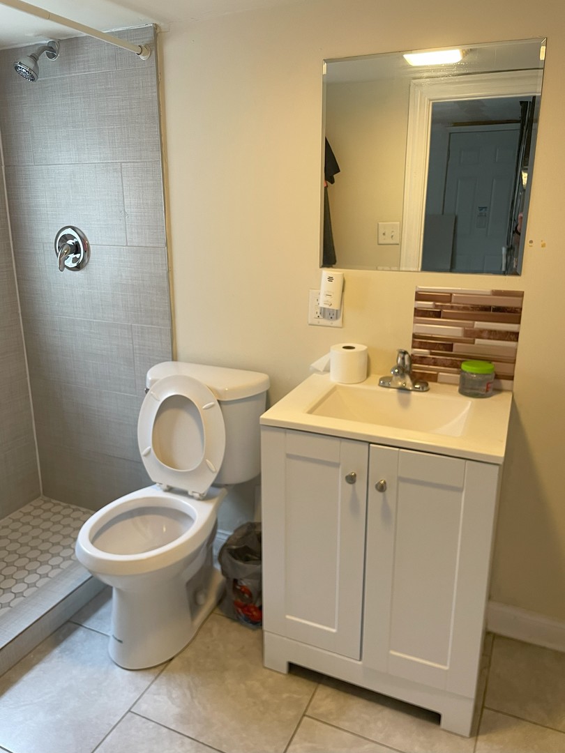 14647 Irving Avenue Dolton, IL 60419 - Photo 14 of 24 a bathroom with a sink toilet and mirror