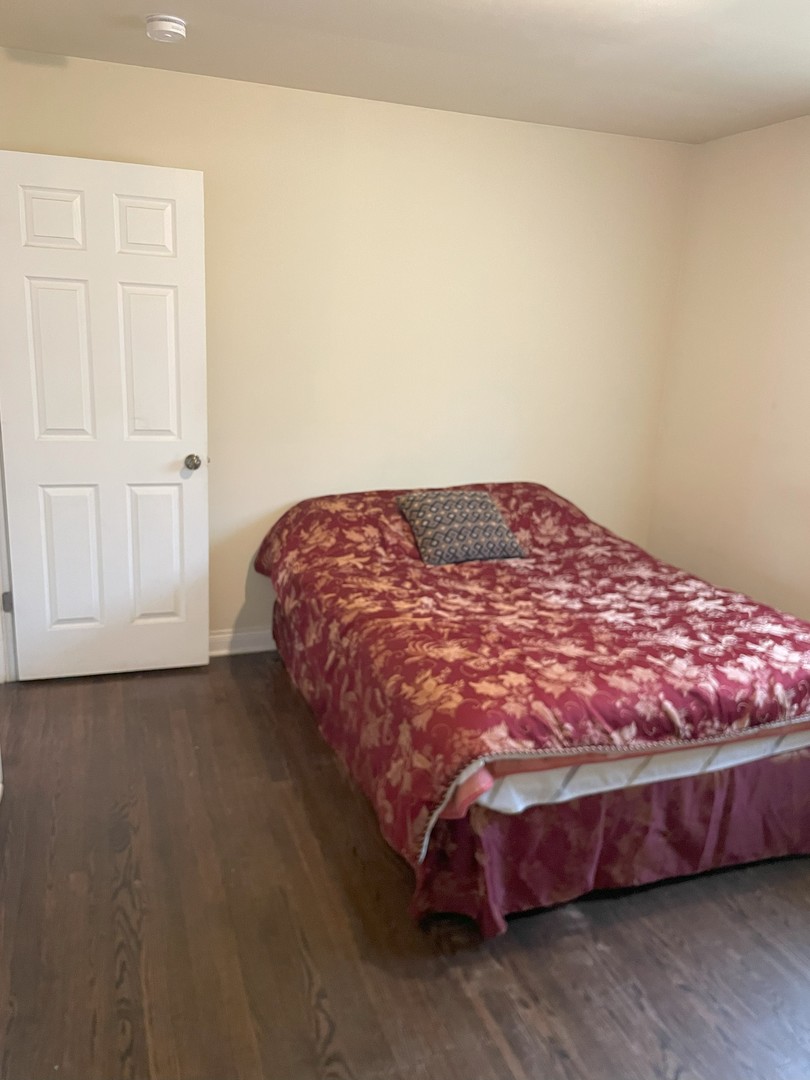 14647 Irving Avenue Dolton, IL 60419 - Photo 16 of 24 a bedroom with a bed and wooden floor