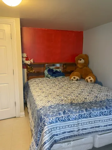 a bedroom with a bed and a mirror