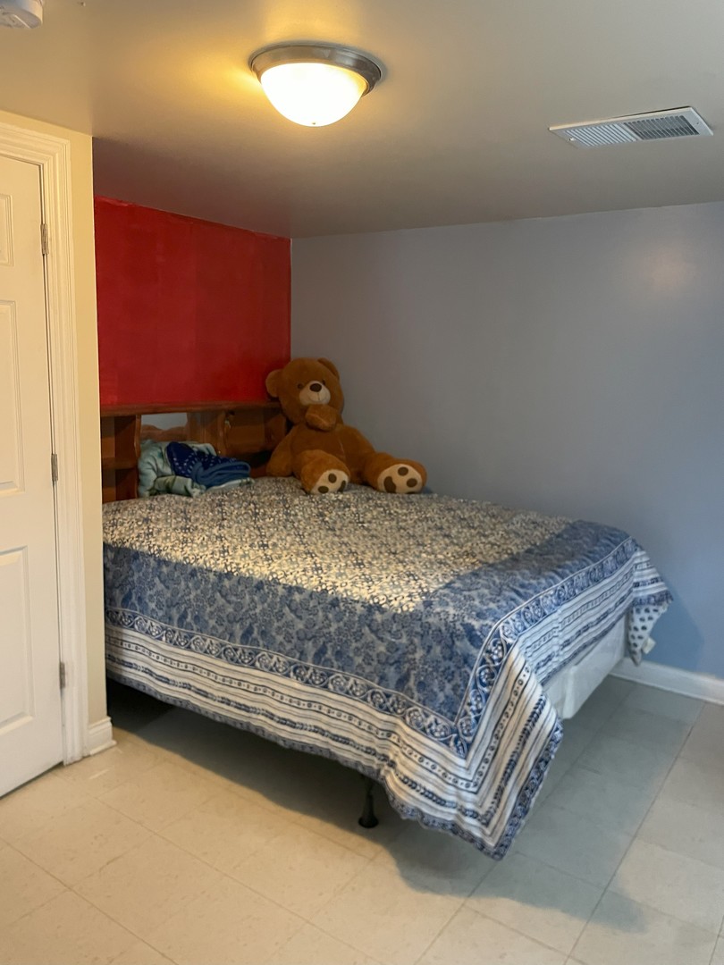 14647 Irving Avenue Dolton, IL 60419 - Photo 21 of 24 a bedroom with a bed and a mirror