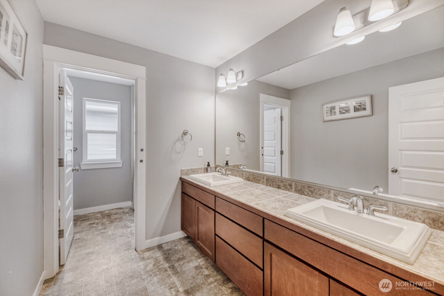 3626 222nd Place Southeast Bothell, WA 98021 - Photo 19 of 27 a spacious bathroom with a double vanity sink and a mirror