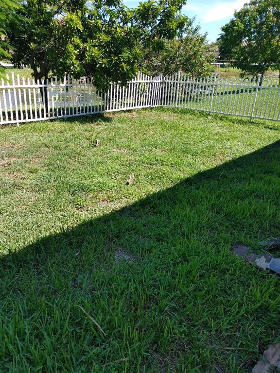 5004 Northwest 49th Road Tamarac, FL 33319 - Photo 11 of 16 a view of a bench in the garden