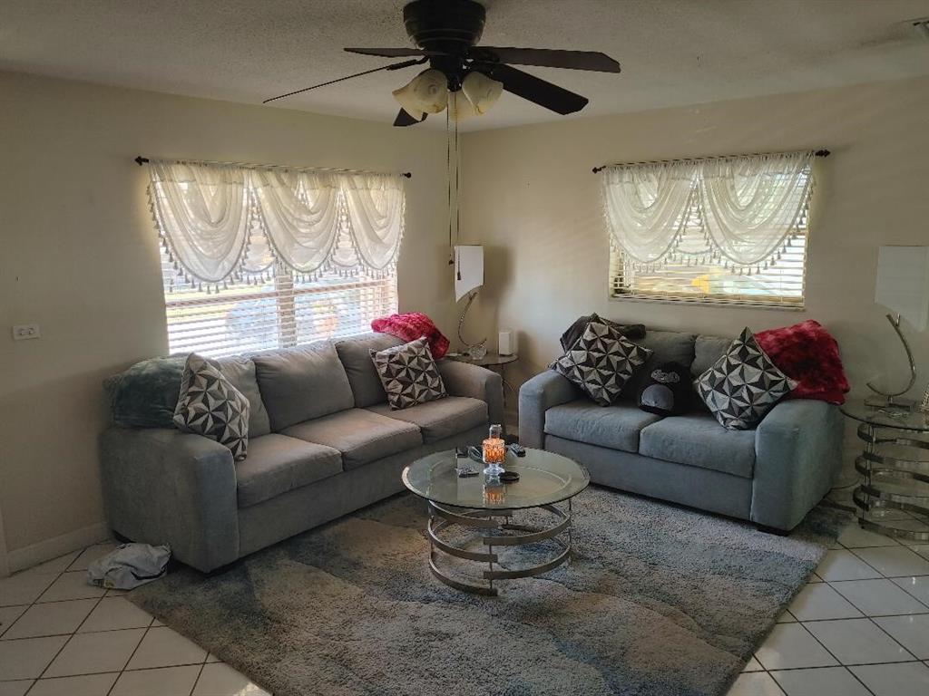 5004 Northwest 49th Road Tamarac, FL 33319 - Photo 2 of 16 a living room with furniture and a large window