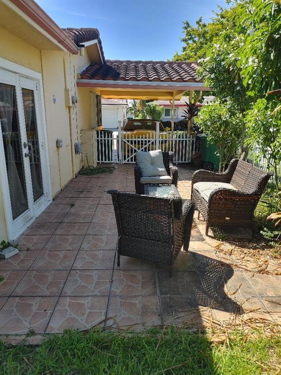 5004 Northwest 49th Road Tamarac, FL 33319 - Photo 9 of 16 a view of a patio with a table and chairs