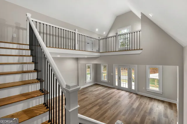 a view of entryway with wooden floor and front door