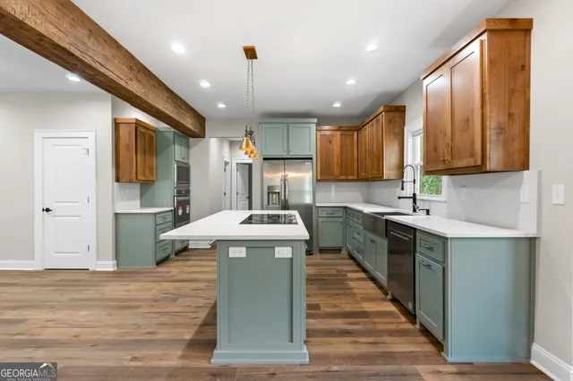 a kitchen with stainless steel appliances granite countertop a sink a stove and a refrigerator