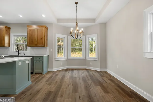 a kitchen with stainless steel appliances granite countertop wooden floors a sink and a window
