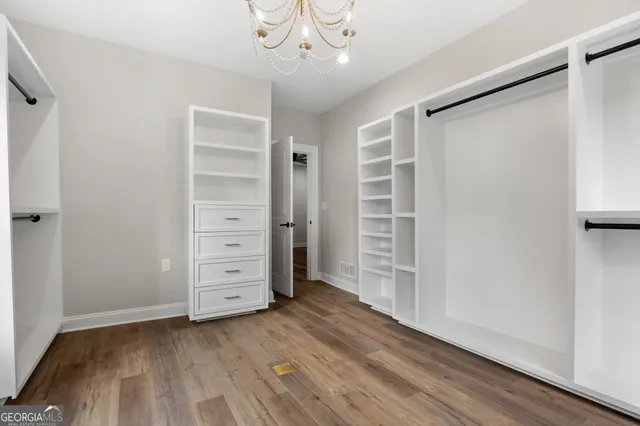 a view of walk in closet with empty racks
