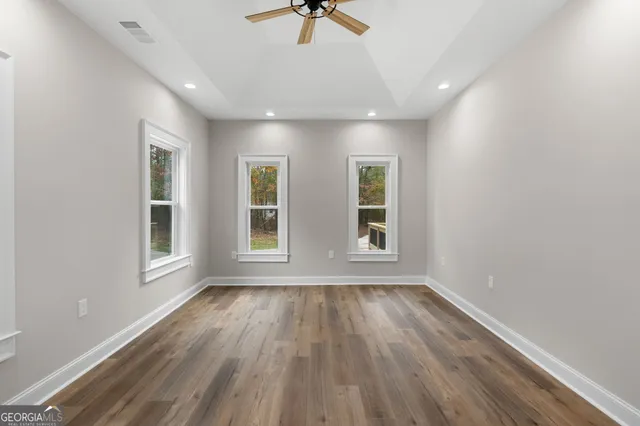 wooden floor in an empty room with a window