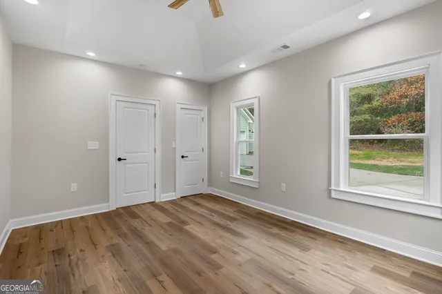 wooden floor in an empty room with a window