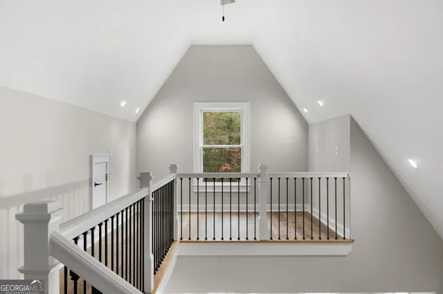 an empty room with fan and windows