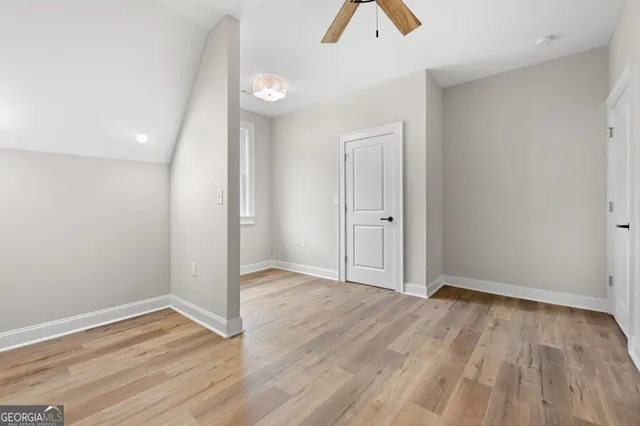 a bathroom with a granite countertop sink a toilet and a mirror