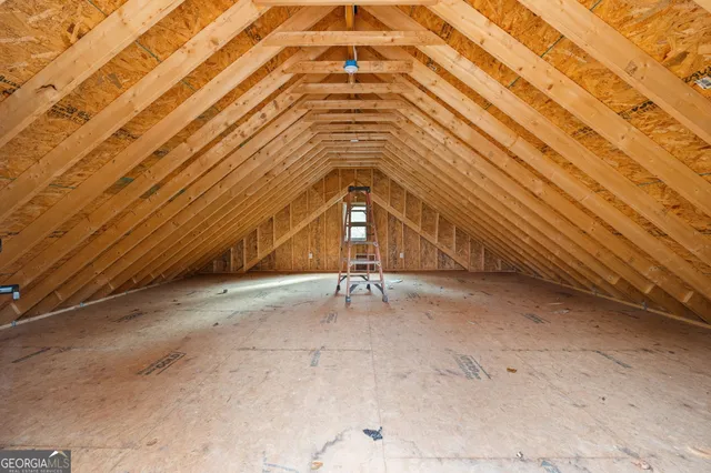 a view of a house with a small yard and wooden fence