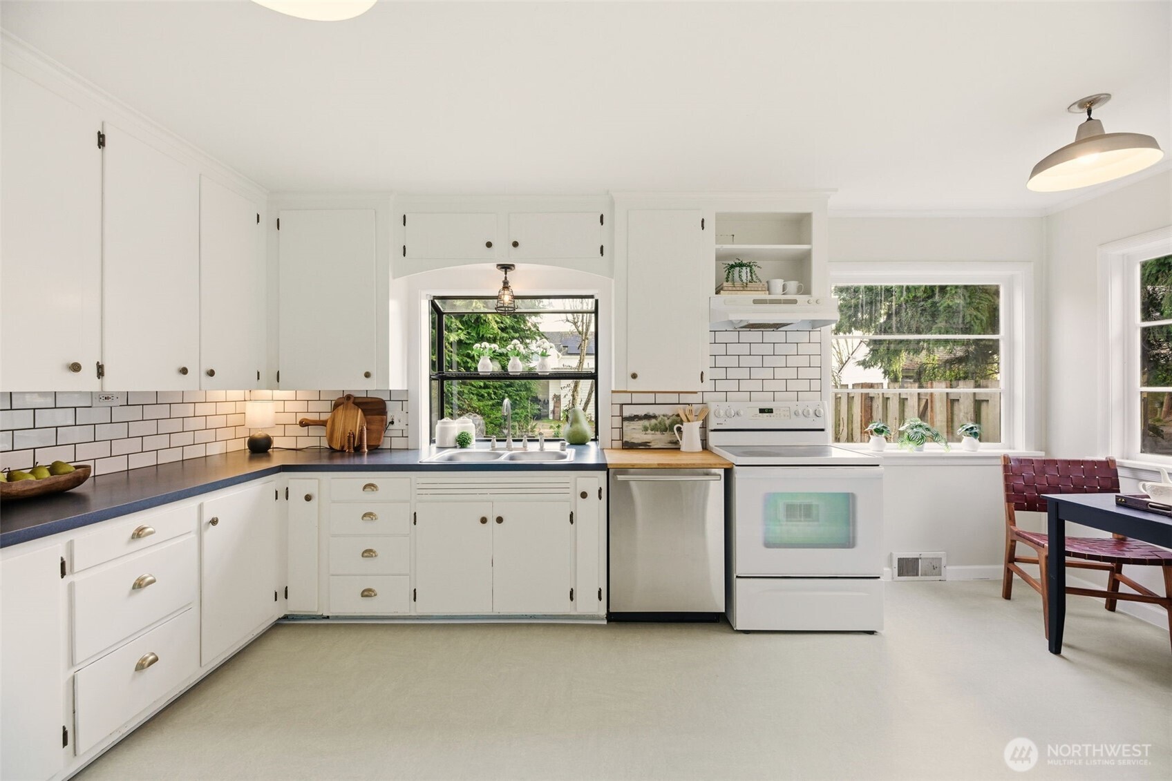 217 6th Street Snohomish, WA 98290 - Photo 15 of 40 a large white kitchen with granite countertop white cabinets and white appliances
