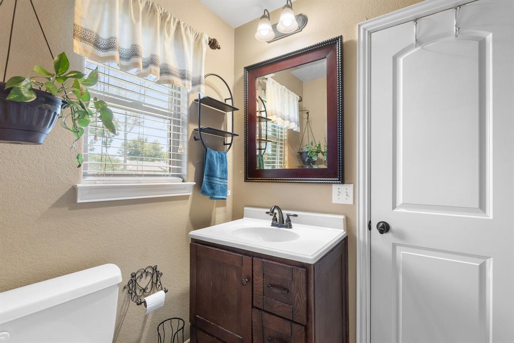 4504 Jennings Avenue Wichita Falls, TX 76310 - Photo 21 of 26 a bathroom with a sink a toilet and a mirror