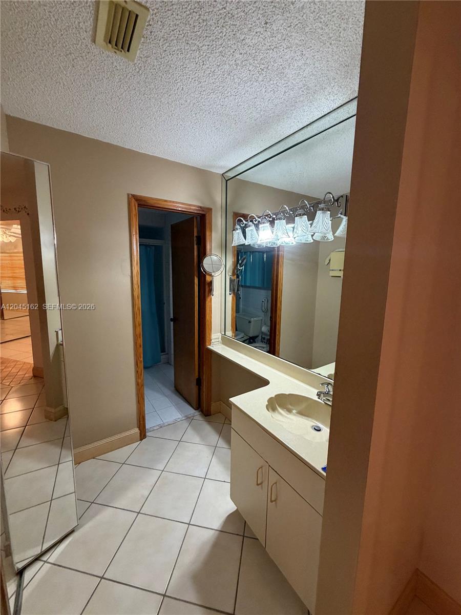 3262 Southwest 139th Place Miami, FL 33175 - Photo 23 of 36 a bathroom with a sink and a mirror