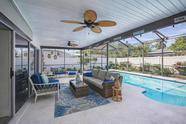 a living room with couch and a floor to ceiling window