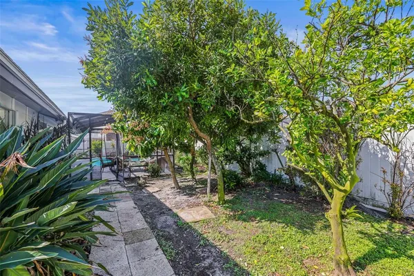 a backyard of a house with table and chairs