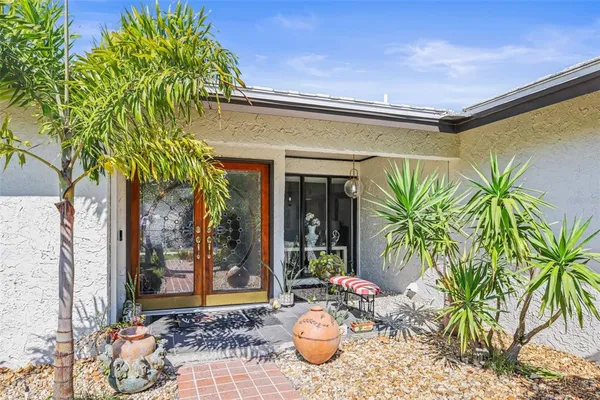 a front view of a house with outdoor seating