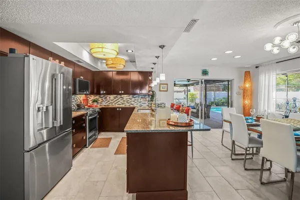 a kitchen with refrigerator and cabinets