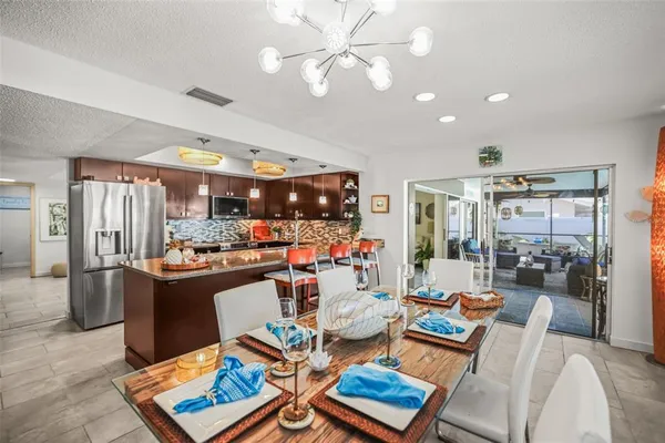 a living room with lots of furniture and kitchen view