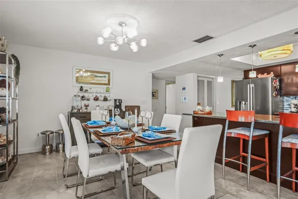 a view of a dining room with furniture and chandelier
