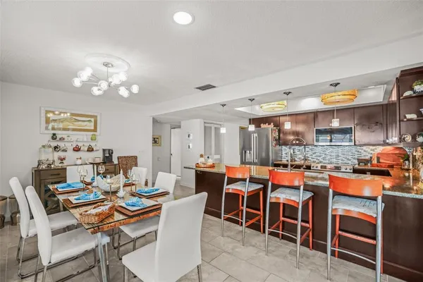 a dining room with a table and chairs