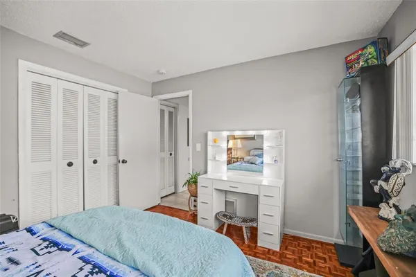 a bedroom with a bed and a dresser in it