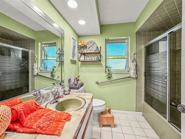 a bathroom with a sink mirror vanity and toilet