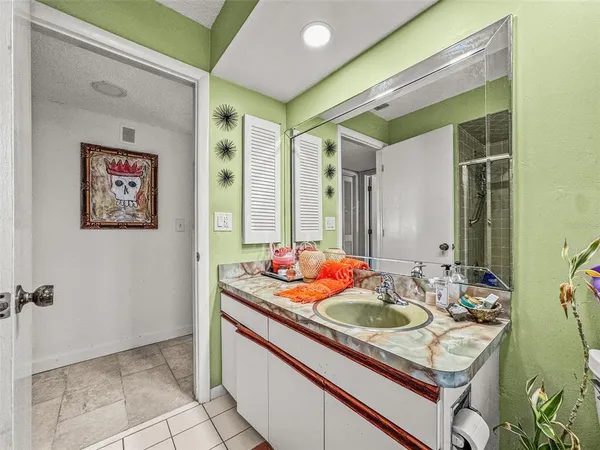 a bathroom with a sink a mirror and a shower